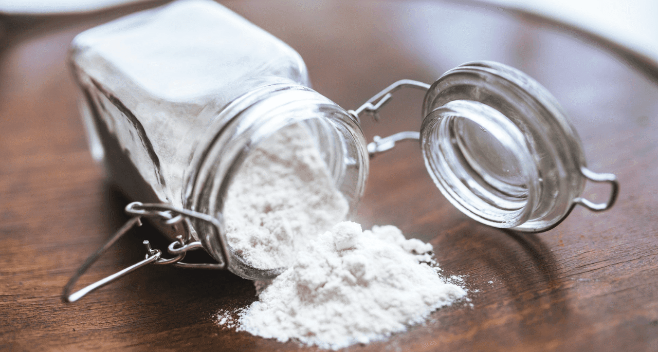 Baking soda spilling out of glass jar