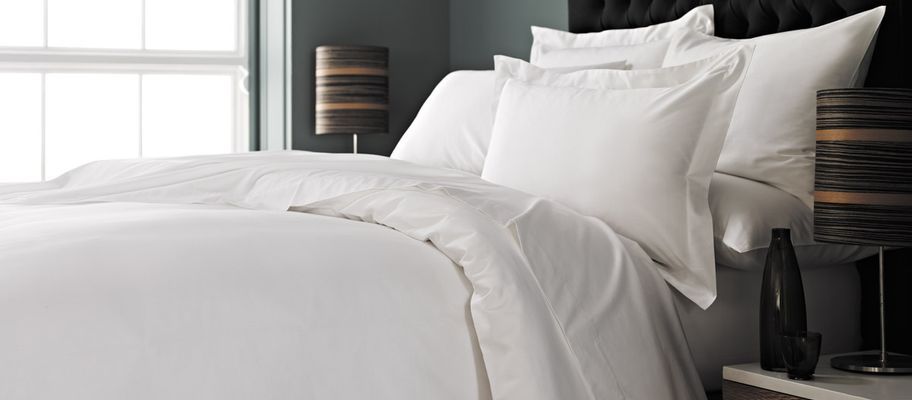 White bedding with black headboard