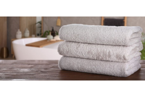 White towels stacked in a hotel bathroom