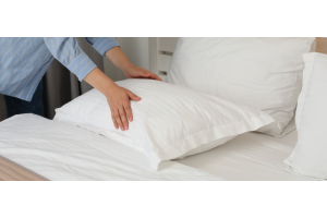 Woman changing a guest bed
