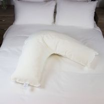 V shaped pillow sitting on bed, with waterproof and flame retardant protection,