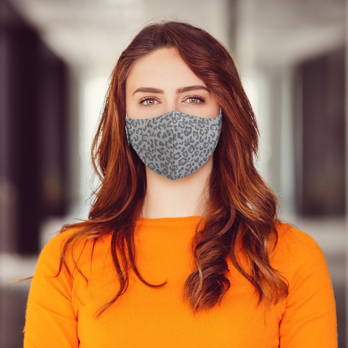 Woman wearing Martex Health leopard print grey coloured reusable face mask with antimicrobial protection.