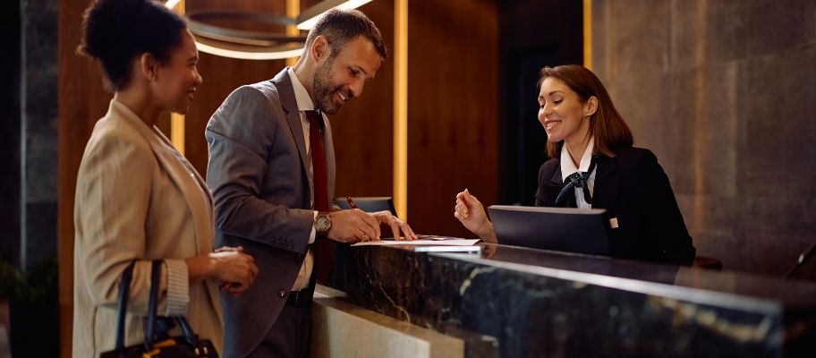 Business travelers checking in at a hotel reception