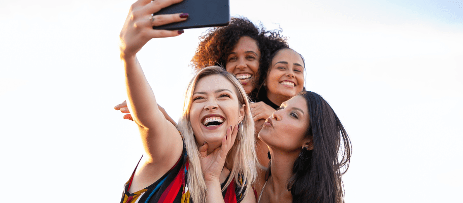 Female Friends Taking Group Selfie