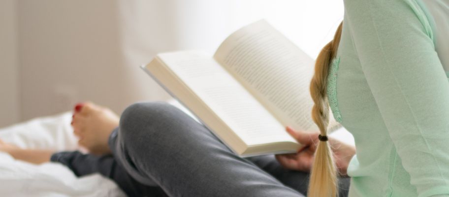Woman reading a book in bed