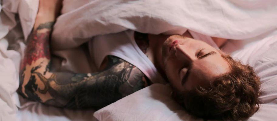 Young man sleeping in bed